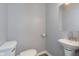 Convenient half bathroom with pedestal sink and toilet at 209 Trowbridge St, Indianapolis, IN 46201
