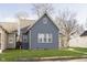 Rear view of a gray house with white trim and a grassy yard at 209 Trowbridge St, Indianapolis, IN 46201