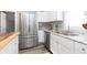 Bright kitchen with stainless steel refrigerator and white cabinets at 209 Trowbridge St, Indianapolis, IN 46201
