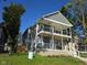 Charming two-story home with a front porch, balcony, and green lawn at 3258 N Park Ave, Indianapolis, IN 46205