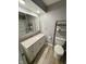 Modern bathroom featuring white vanity, updated fixtures, and wood-look flooring at 2005 N Knighthood Grv, Shelbyville, IN 46176