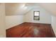 Finished attic space with hardwood floors, window AC, and natural light at 2304 N Hollywood Ave, Muncie, IN 47304