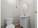 Simple bathroom with white vanity and a round mirror at 3125 N Tacoma Ave, Indianapolis, IN 46218