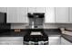 Updated kitchen with stainless steel range and dark countertops at 3125 N Tacoma Ave, Indianapolis, IN 46218