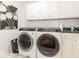 Laundry room with white cabinets, front-loading washer and dryer at 333 Jordan Rd, Indianapolis, IN 46217