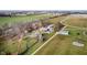 Aerial view of property with outbuildings, driveway, and wooded areas at 432 500 N, Anderson, IN 46012