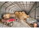 Barn interior with hay bales, Kawasaki Mule, and storage at 432 500 N, Anderson, IN 46012