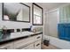 Bathroom with white vanity, shower/tub combo, and window at 432 500 N, Anderson, IN 46012