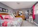 Pink and gray bedroom with floral bedding and vanity at 432 500 N, Anderson, IN 46012