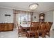 Dining room featuring a large wooden table with seating for eight and a window view at 432 500 N, Anderson, IN 46012