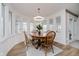 Bright dining area with large windows, wood table, and modern light fixture at 432 500 N, Anderson, IN 46012