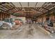 Spacious garage interior with tractors, construction equipment, and ample storage at 432 500 N, Anderson, IN 46012