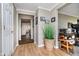 Hallway with hardwood floors, decorative plant, and access to other rooms at 432 500 N, Anderson, IN 46012