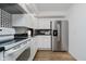 Modern white kitchen with stainless steel appliances and black countertops at 432 500 N, Anderson, IN 46012