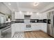 Updated kitchen with white cabinetry, stainless steel appliances, and a stylish backsplash at 432 500 N, Anderson, IN 46012