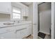 Functional laundry room with washer, dryer, sink, cabinets, and adjacent full bathroom at 432 500 N, Anderson, IN 46012