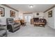 Inviting living room centered around fireplace, french doors, leather furniture, and plush carpet at 432 500 N, Anderson, IN 46012
