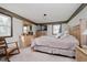 Main bedroom with neutral decor, rocking chair, and ensuite access at 432 500 N, Anderson, IN 46012