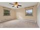 Bedroom with neutral carpeting, ceiling fan, and ample closet space at 4529 Dickson Rd, Indianapolis, IN 46226