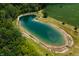 An aerial view showcasing a tranquil pond with a gazebo at 4832 E 200 N, Anderson, IN 46012