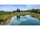 Aerial view of the property with a pond, house, and surrounding greenery at 4832 E 200 N, Anderson, IN 46012