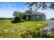 Side view of a ranch-style home with a covered porch and landscaping at 4832 E 200 N, Anderson, IN 46012