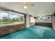 Sunroom with green carpet, large windows, and view of pond at 4832 E 200 N, Anderson, IN 46012