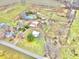 Aerial view of property highlighting a house, barn, and pond amidst farmlands at 7021 Bellsville Pike, Columbus, IN 47201