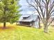 Rustic log cabin with a covered porch and metal roof, nestled in a green lawn at 7021 Bellsville Pike, Columbus, IN 47201