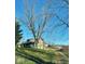 Rustic log cabin nestled on a spacious lot with mature trees at 7021 Bellsville Pike, Columbus, IN 47201