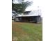 Rustic log home with covered porch and metal roof at 7021 Bellsville Pike, Columbus, IN 47201