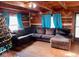 Cozy living room featuring a sectional sofa and wood-paneled walls at 7021 Bellsville Pike, Columbus, IN 47201