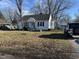 Charming single-story home with a teal front door, attached garage, and driveway at 1605 S Norfolk St, Indianapolis, IN 46241