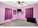 Purple bedroom with gray carpet, ceiling fan, and two TVs at 2335 Union St, Indianapolis, IN 46225