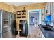 Kitchen with stainless steel appliances, wood-paneled walls, and view of the living area at 2335 Union St, Indianapolis, IN 46225