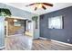 Living area with wood-look flooring, an arched entryway, and a wood accent wall at 2335 Union St, Indianapolis, IN 46225