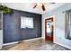 Living room with gray wood-look flooring, a ceiling fan, and gray and light blue walls at 2335 Union St, Indianapolis, IN 46225