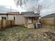 Fenced backyard with small wooden porch and AC unit at 416 N Mulberry St, Muncie, IN 47305