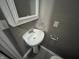 Half bathroom with pedestal sink and white cabinetry at 416 N Mulberry St, Muncie, IN 47305