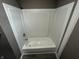 White shower/tub combo with gray flooring in bathroom at 416 N Mulberry St, Muncie, IN 47305