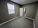 Empty bedroom with gray walls, white trim, and gray wood-look flooring at 416 N Mulberry St, Muncie, IN 47305
