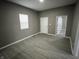 Bedroom with gray walls, wood-look flooring, and ample natural light at 416 N Mulberry St, Muncie, IN 47305