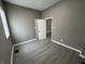 Spacious bedroom with gray walls, wood-look flooring, and white trim at 416 N Mulberry St, Muncie, IN 47305