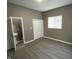 Main bedroom with wood-look floors, closet, and ensuite half-bath at 416 N Mulberry St, Muncie, IN 47305