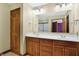 Double vanity bathroom with wood cabinets and a large mirror at 4725 W Harrisburg Ct, New Palestine, IN 46163