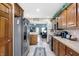 Galley kitchen with stainless steel appliances and wood cabinets at 4725 W Harrisburg Ct, New Palestine, IN 46163