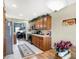 Kitchen with wood cabinets, stainless steel appliances, and view to living room at 4725 W Harrisburg Ct, New Palestine, IN 46163