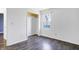 Empty bedroom with closet, dark wood-look laminate flooring, and white walls at 513 Mary St, Shelbyville, IN 46176