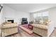 Cozy living room with a fireplace, plush seating, and large windows at 5655 Lighthouse Dr, Brownsburg, IN 46112