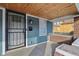 Covered front porch with wood ceiling, security door, and brick accents at 620 N Rural St, Indianapolis, IN 46201